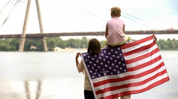 Family with Children Holding American Flag