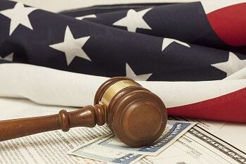 Gavel With American Flag and Immigration Paperwork